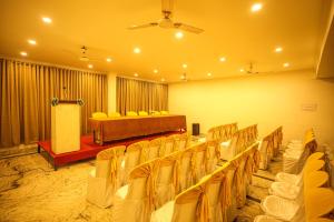 a room with rows of chairs and a stage at Liwa Tower Hotel & Business Center in Kunnamkulam