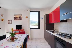 a kitchen with a table and a counter top at Bussana Mare in Bussana Nuova