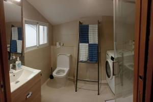 a bathroom with a toilet and a sink and a shower at Mirador Porta da Vila, Noia in Noya +11 photos