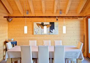 a dining room with a table and white chairs at Réveil féerique au cœur des alpes - Vercorin in Vercorin