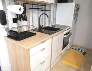 a small kitchen with a sink and a stove at Best Place for You in Batumi