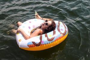 a woman laying in the water on a raft in the water at Douro4sailing in Porto +58 photos