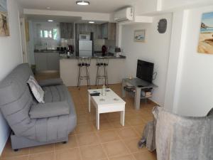 a living room with a couch and a table at Modern Apartment Near Beach in La Mata