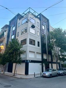 a building with two cars parked in front of it at AthensOwl in Athens