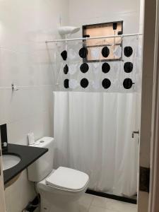 a bathroom with a toilet and a shower curtain at Loft no Hotel Quitandinha in Petrópolis
