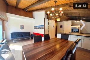 ein Wohnzimmer mit einem Holztisch und einem blauen Sofa in der Unterkunft La Remointze in Veysonnaz