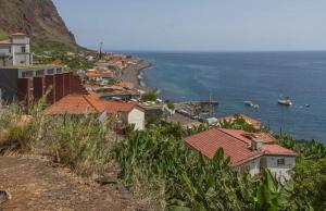 a town on a hill next to the ocean at Tides proprety - Low tide in Paul do Mar +13 photos