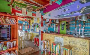 a bar with a surfboard on the wall at Tides proprety - Low tide in Paul do Mar