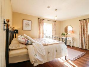 a bedroom with a bed and a window at Bluebell Cottage in Rugeley