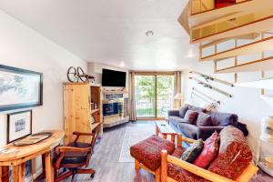 a living room with a couch and a table at Summit House East 113 in Copper Mountain