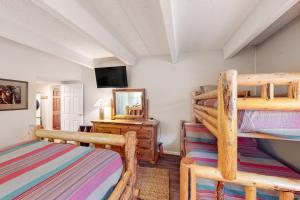 a bedroom with two bunk beds and a mirror at Summit House East 113 in Copper Mountain