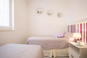 Postel nebo postele na pokoji v ubytování Apartments Oleandar