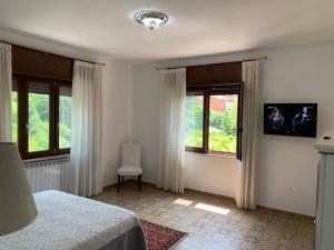 a bedroom with a bed and two windows at Casa vacanza in Cassino