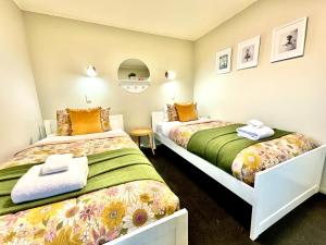 two beds in a small room with at Free-Range On Papmoa Beach in Tauranga