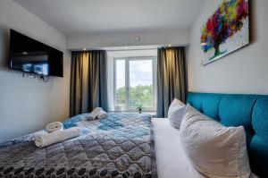 ein Schlafzimmer mit einem Bett und einem großen Fenster in der Unterkunft FeWo Prora - Heimathafen Penthouse in Binz