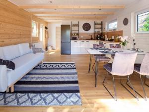a kitchen and living room with a couch and a table at Chalet in Köln - Tinyhouse in Cologne