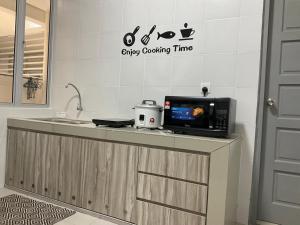 a kitchen with a microwave on a counter at Sweet Homestay The Venus Sitiawan 温馨民宿 in Sitiawan