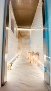 a hallway with a table and benches in a building at Faro Capo Spartivento in Chia