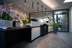 a flower shop with vases of flowers on a counter at th Hotel Leipzig Messe in Leipzig