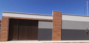 a building with two garage doors on the side at Casa em barreirinhas in Barreirinhas