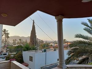 a view from the balcony of a house with a palm tree at BnB La Luna Entire Apartment in Jericho