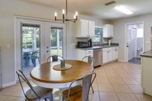 a kitchen and dining room with a table and chairs at Dog-Friendly Vero Beach Retreat with Porch and Grill! in Vero Beach