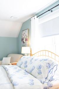 A bed or beds in a room at Biddle Point Inn