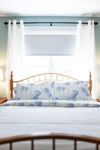 A bed or beds in a room at Biddle Point Inn