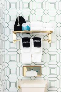 a bathroom with a shelf above a toilet at Biddle Point Inn in Plymouth