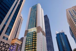 a tall building in a city with tall buildings at Element by Westin City Center Doha in Doha