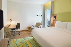 a hotel room with a large bed and a desk at Element by Westin City Center Doha in Doha