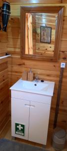 a bathroom with a white sink and a mirror at Quinta D' LuzArcoIris in Arganil