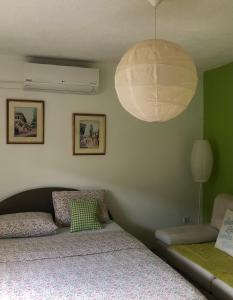 a bedroom with two beds and a large light fixture at Apartment Incognito in Sarajevo
