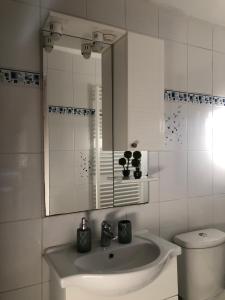 a white bathroom with a sink and a toilet at Apartment Incognito in Sarajevo +34 photos