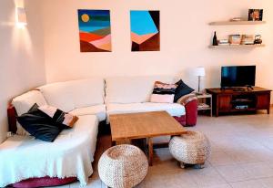 a living room with a couch and a table at Maison de charme au pays du vin - Charming House in Wine Country in Montcaret