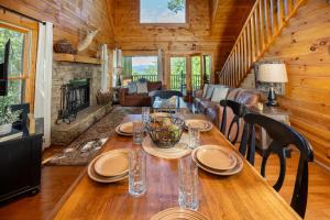 une salle à manger avec une table en bois et une cheminée dans l'établissement Snowshoe Lodge, à Sevierville
