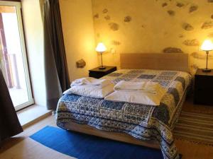 a bedroom with a bed with pillows on it at Quinta do Galgo in Amares