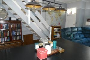 a living room with a table and a blue couch at Aigas in Glasgow