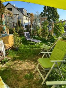 a yard with two lawn chairs and a swing at Diamanthaus deluxe 7 Koblenz in Koblenz +31 photos