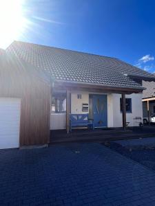 a house with blue doors and a blue bench at Deti's Ferienwohnung in Andernach