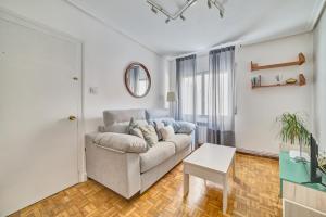 a living room with a couch and a table at Las terrazas de Castañares by Clabao in Logroño