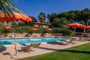 a pool with tables and chairs and umbrellas at Farfalla in Montiano