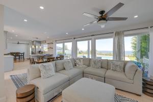 a living room with a white couch and a dining room at Spacious Rocky Point Retreat with Al Fresco Dining! in Rocky Point