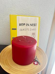 a red cake on a wooden plate with a sign at Hop in Nest Cozy B&B in Wengen in Wengen