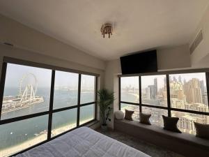 a bedroom with a large window with a view of the city at Amazing views Dubai eye & Palm in Dubai