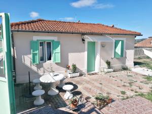 a small house with a table in front of it at Coccinella house in Le Casette