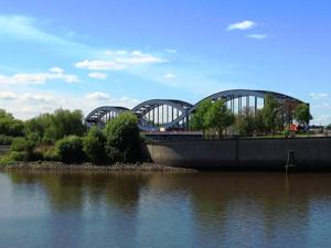 a bridge over a body of water next to the water at Elbbrücken Hotel in Hamburg