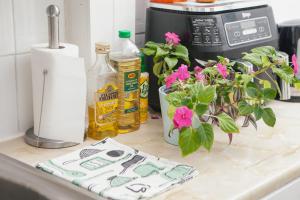 a kitchen counter with a sink with flowers on it at Peaceful Oasis By The Sea in Edinburgh