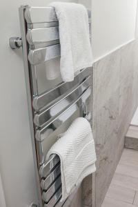a towel rack in a bathroom with towels at Peaceful Oasis By The Sea in Edinburgh
