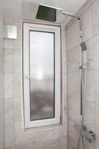 a shower with a window in a bathroom at Peaceful Oasis By The Sea in Edinburgh
